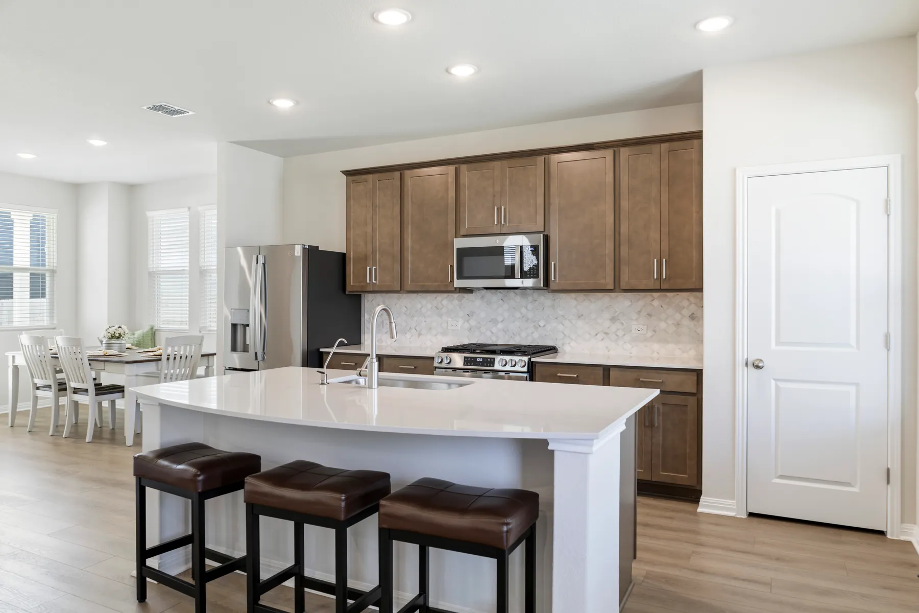 Kitchen island with seating and warm wood cabinets