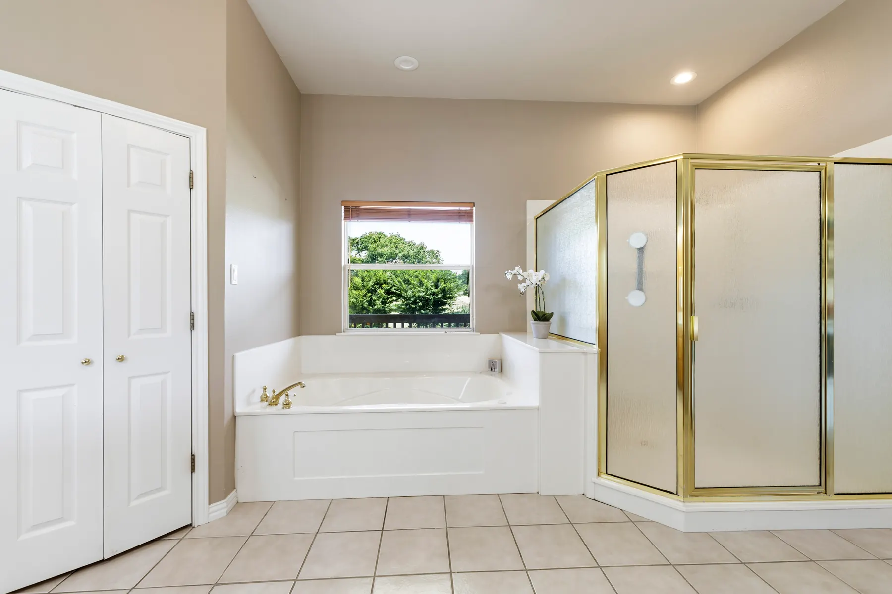 Primary bathroom with soaking tub and glass shower