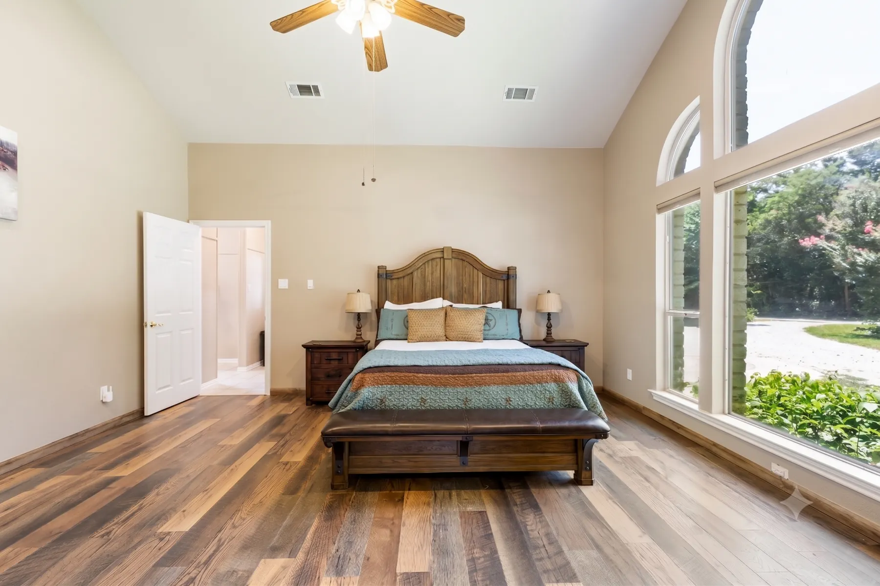 Primary bedroom with arched windows