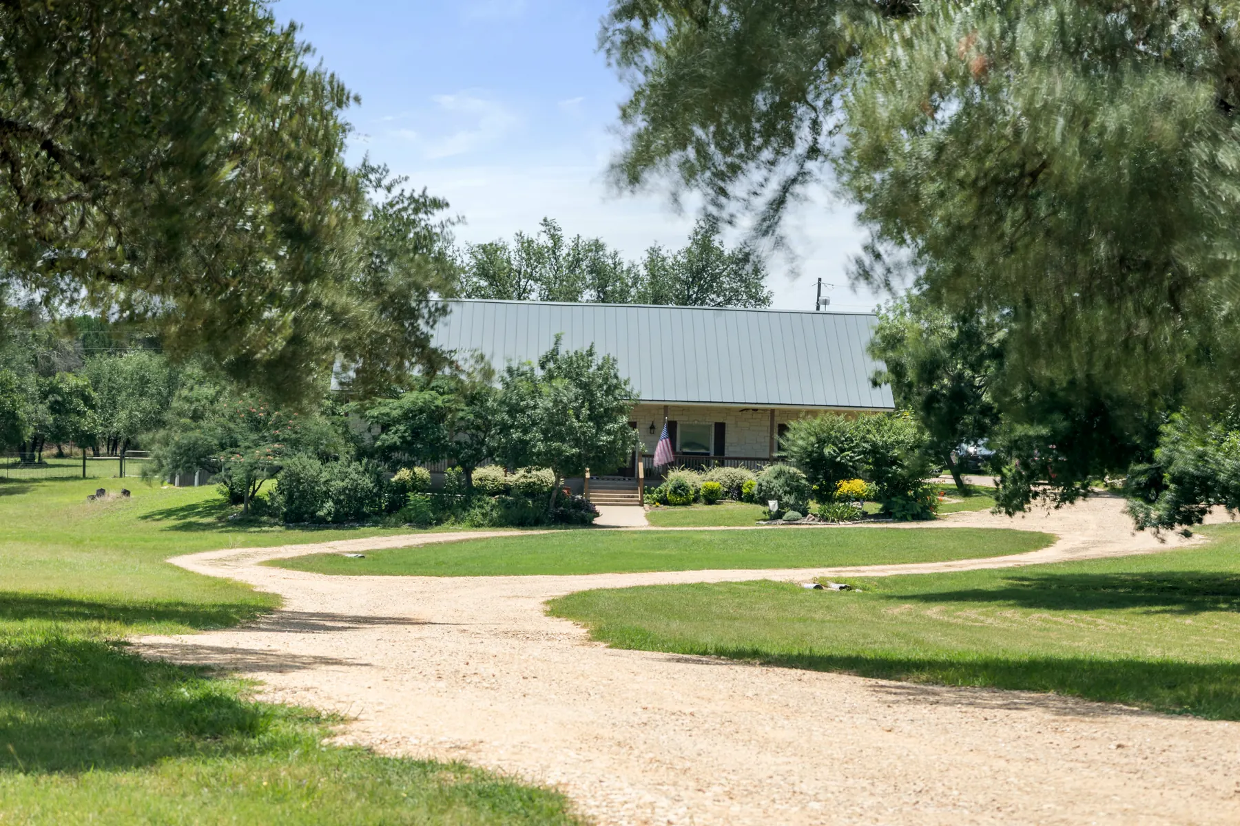 Long approach toward the home through mature trees