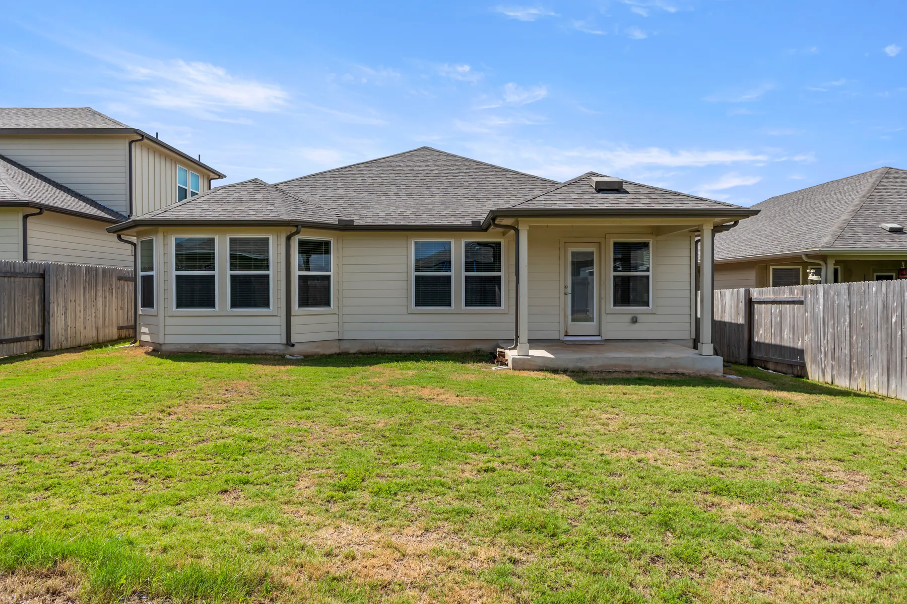 Rear exterior and fenced backyard